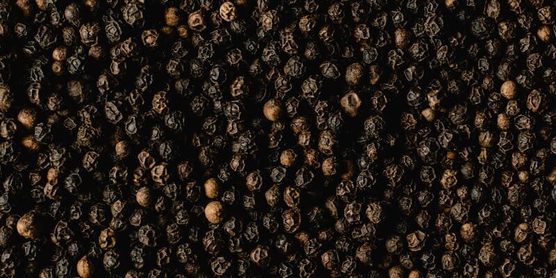 Detailed close-up of black peppercorns showcasing texture and spice quality.
